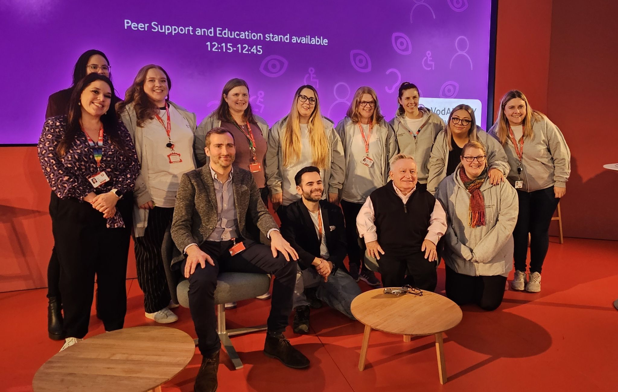 Vodafone employees on stage with Simon Minty at a VodABILITY event in celebration of International Day of Persons with Disabilities.